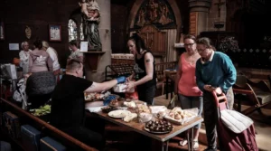Christians distributing food to people in need inside a church